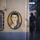 A portrait of a woman is seen near the entrance of the female compartment of a suburban train in Mumbai