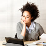 curly-haired woman doing paperwork